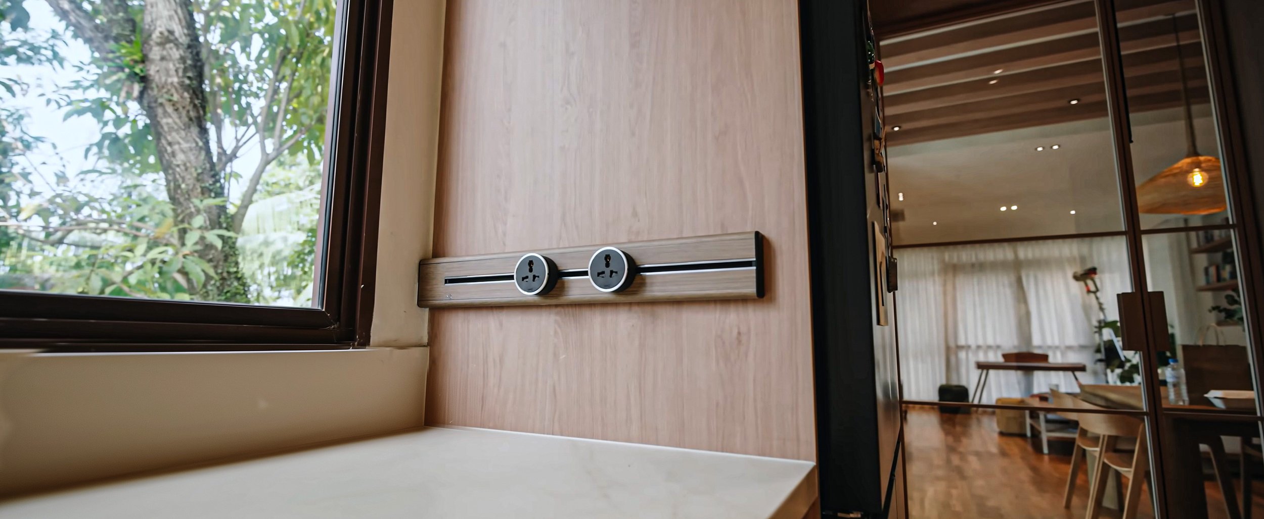 Line8 track supporting various appliances and switches in a clean, elegant kitchen environment.