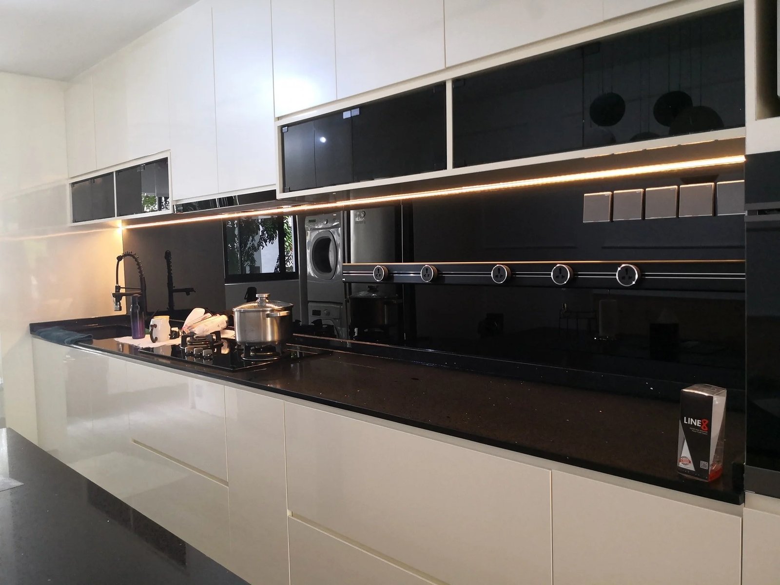 Line8 Model SL track in Black Hairline above the kitchen sink powering lighting