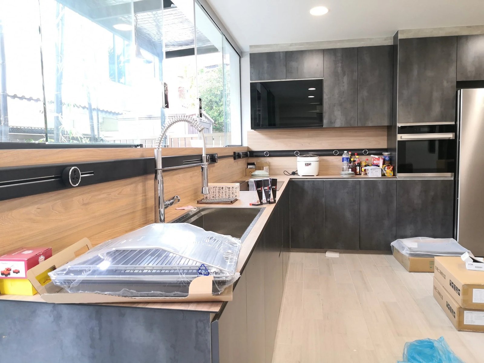 Line8 Model SL track in Black Hairline above the kitchen sink powering appliances