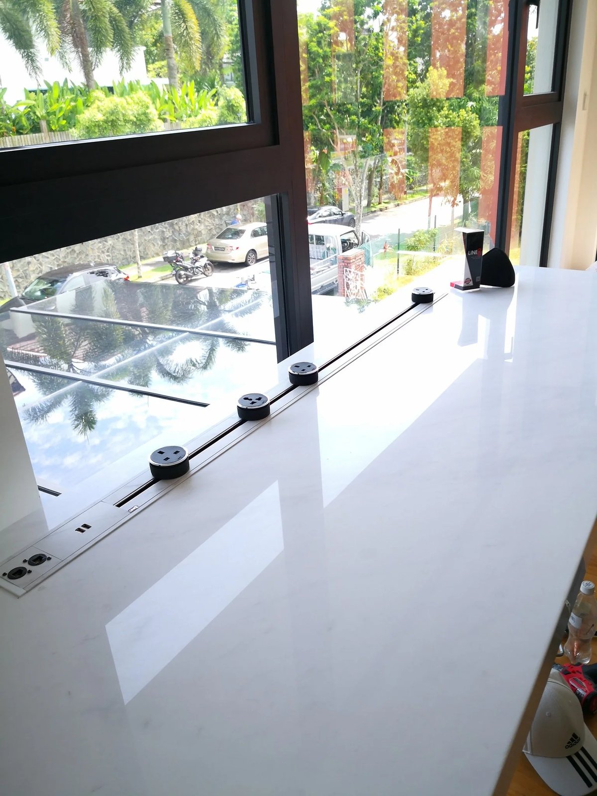 Line8 Model SL track in Pearl White above a study desk powering devices