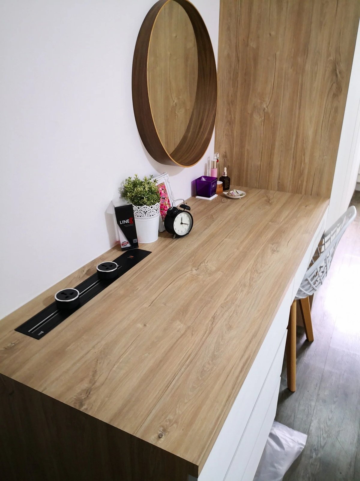 Line8 Model SL track in Black Hairline above a study desk with a clock and decor items
