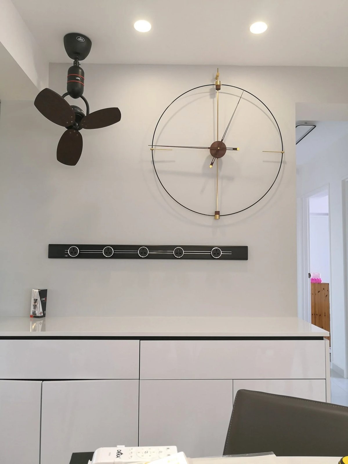 Line8 Model SL track in Black Hairline above a white cabinet