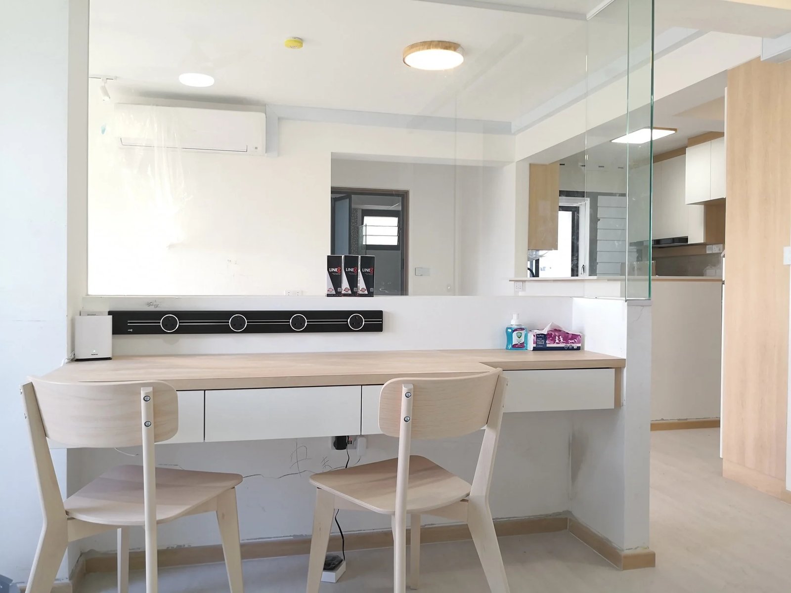 Line8 Model SL track in Black Hairline above a study desk with a mirror