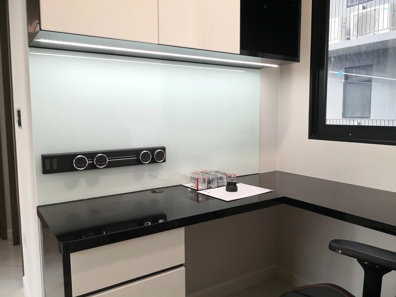 Line8 Model SL track in Black Hairline above a study desk powering lighting and devices