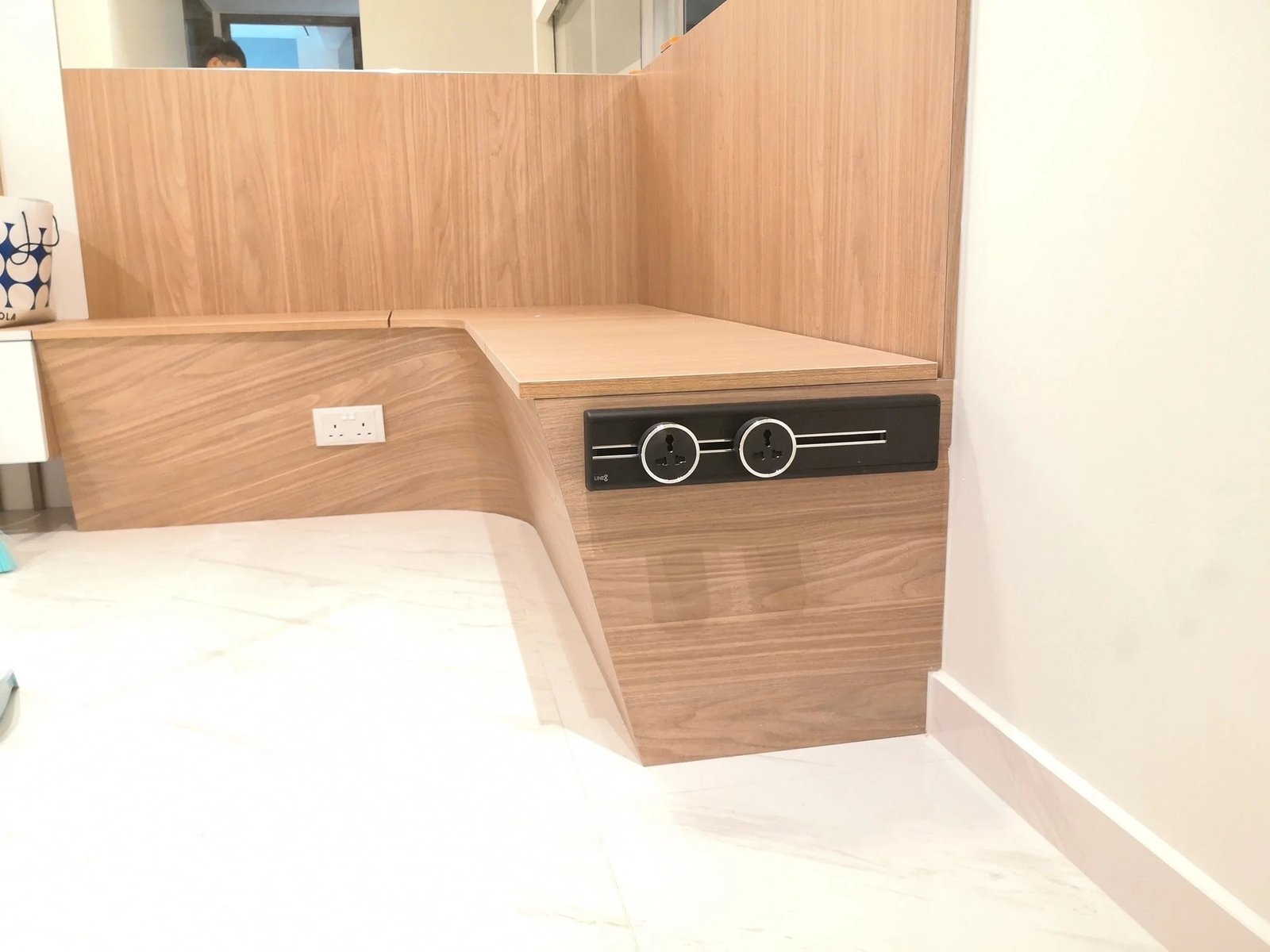 Line8 Model SL track in Black Hairline beside a wooden desk in a living space
