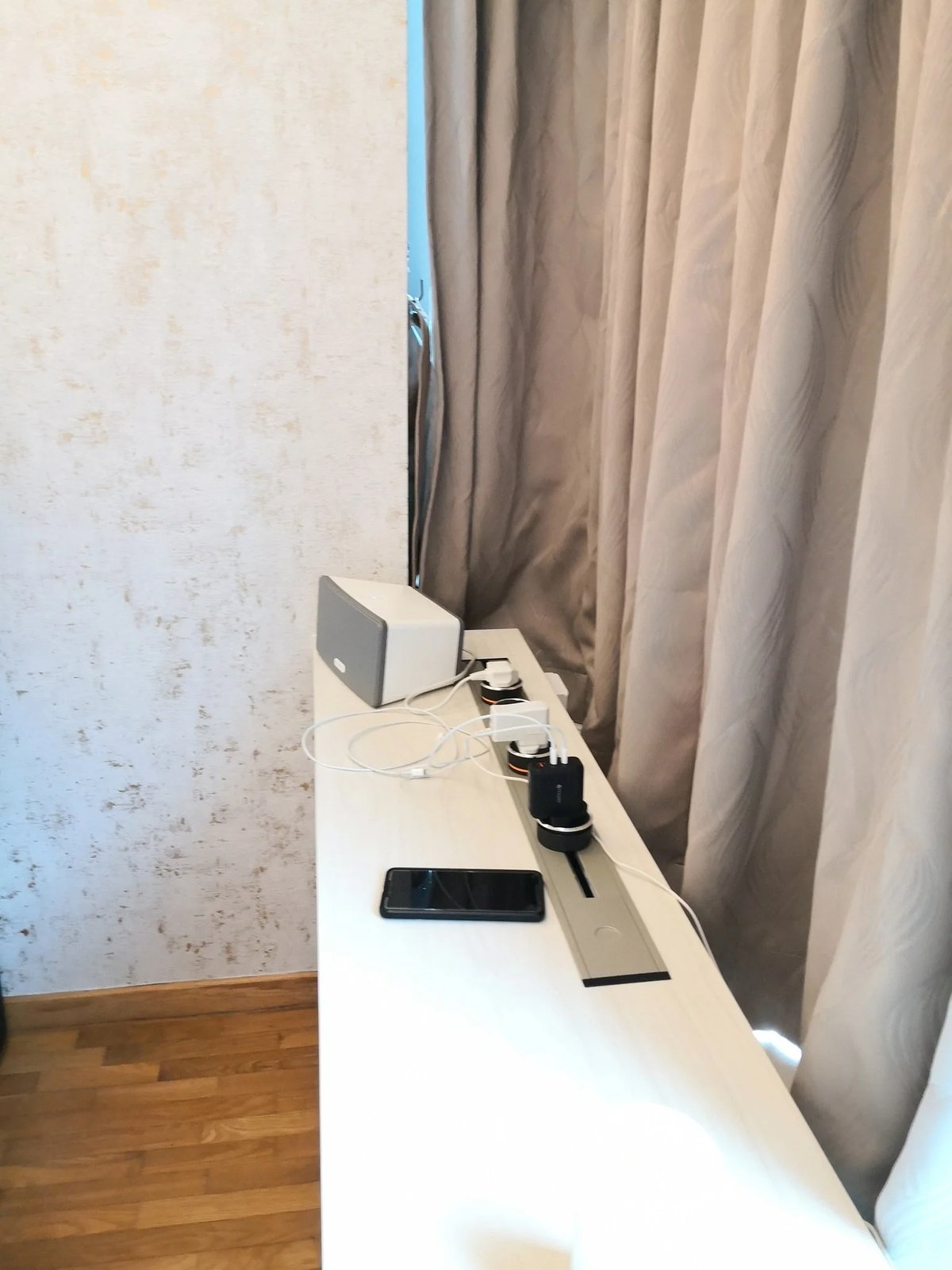 Line8 Model SL track in Black Hairline on a study desk powering devices