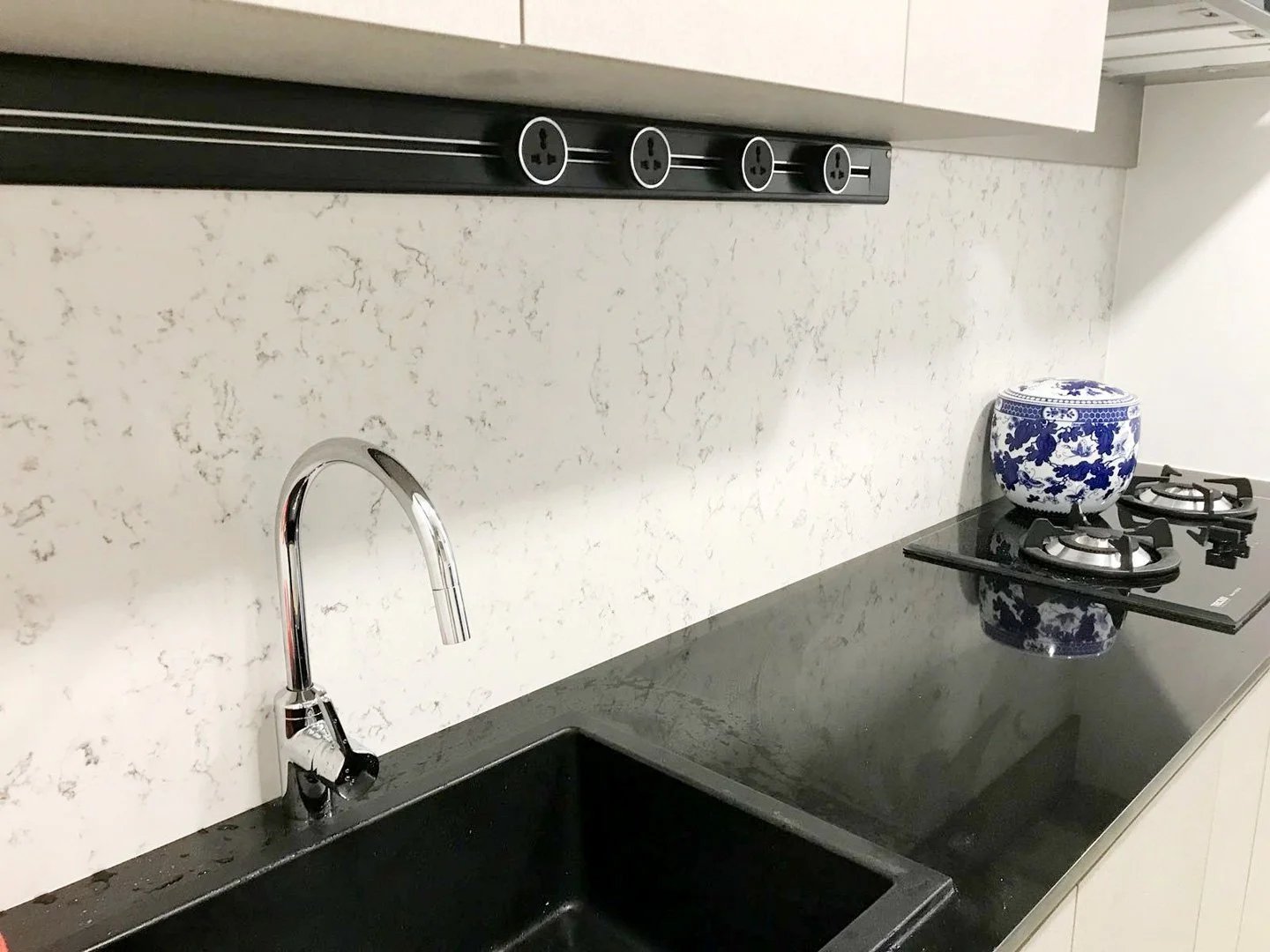 Line8 Model SL track in Black Hairline above a kitchen sink powering lighting