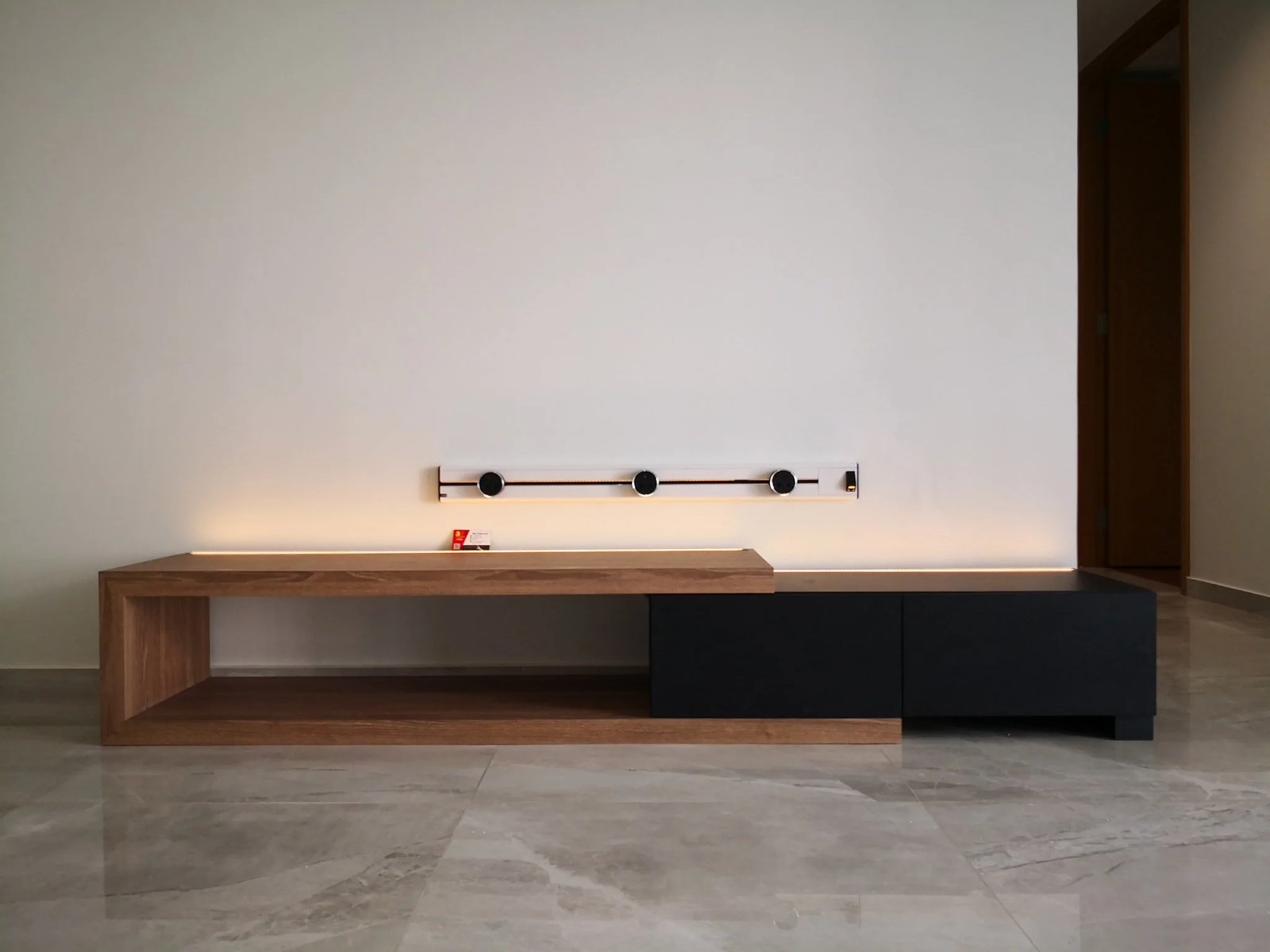 Line8 Model SL track in Black Hairline above a low wooden console table