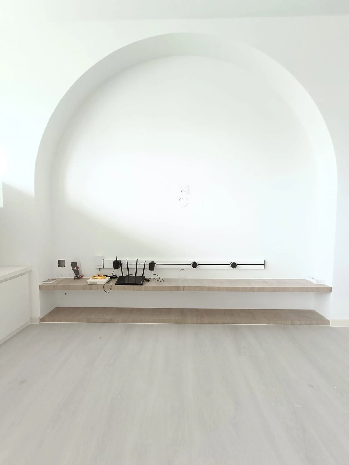 Line8 Model SL track in Black Hairline above a shelf in a living room