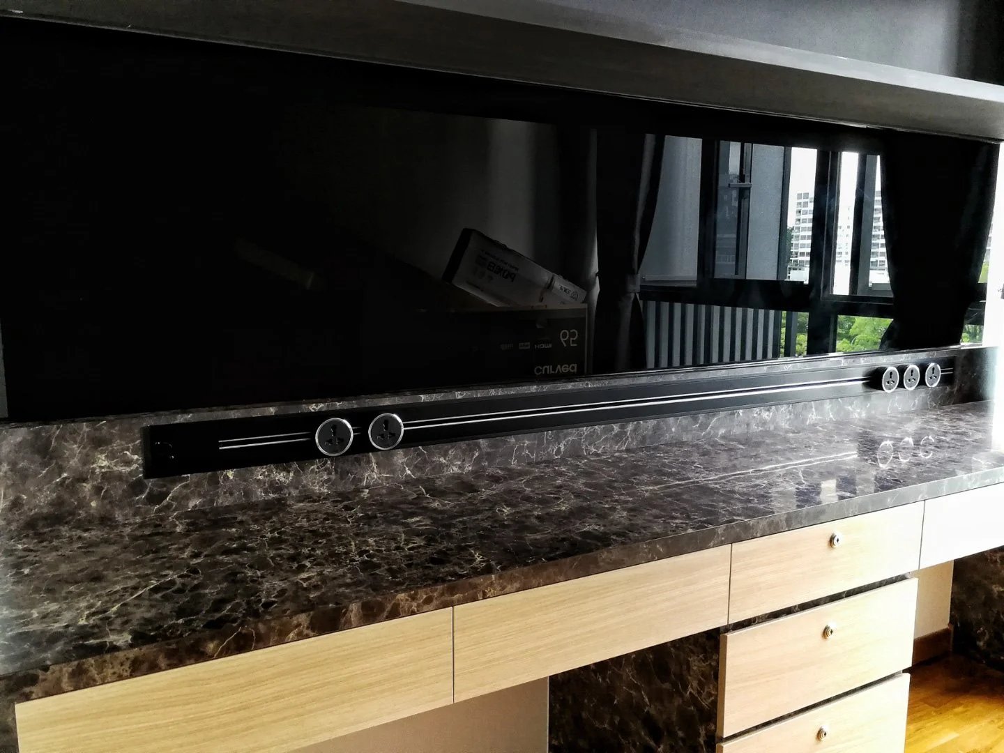 Line8 Model SL track in Black Hairline above a study desk with a marble surface