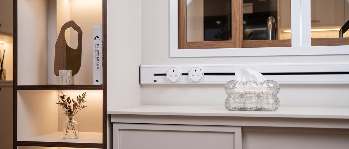 White Line8 adaptors mounted on a wall-mounted track above a kitchen counter near a mirror