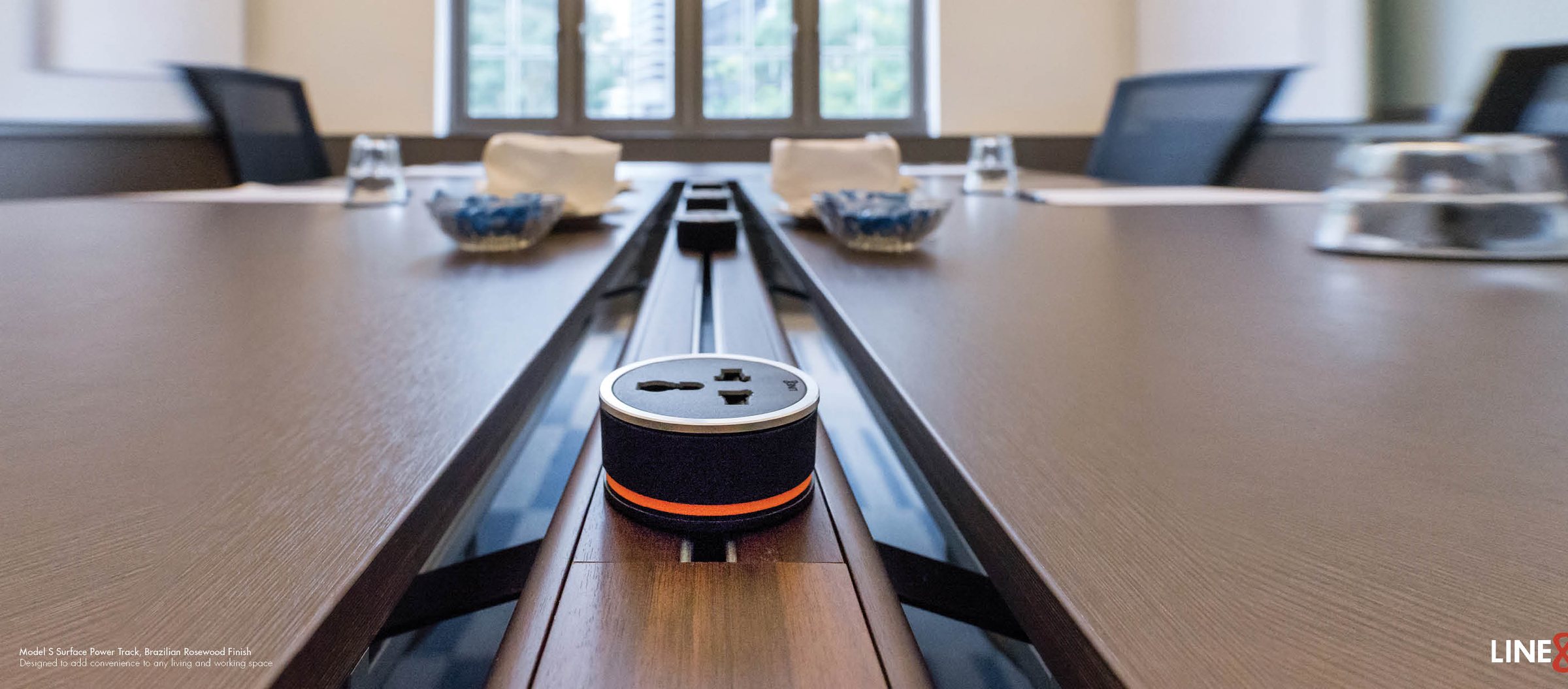 Line8 power track, Brazilian Rosewood finish, recessed into a boardroom conference table