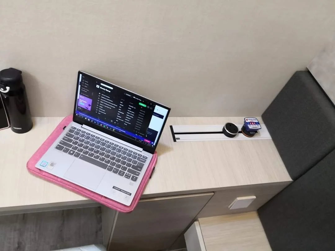 Line8 Model SL track in Black Hairline above a study desk powering a laptop and smart devices