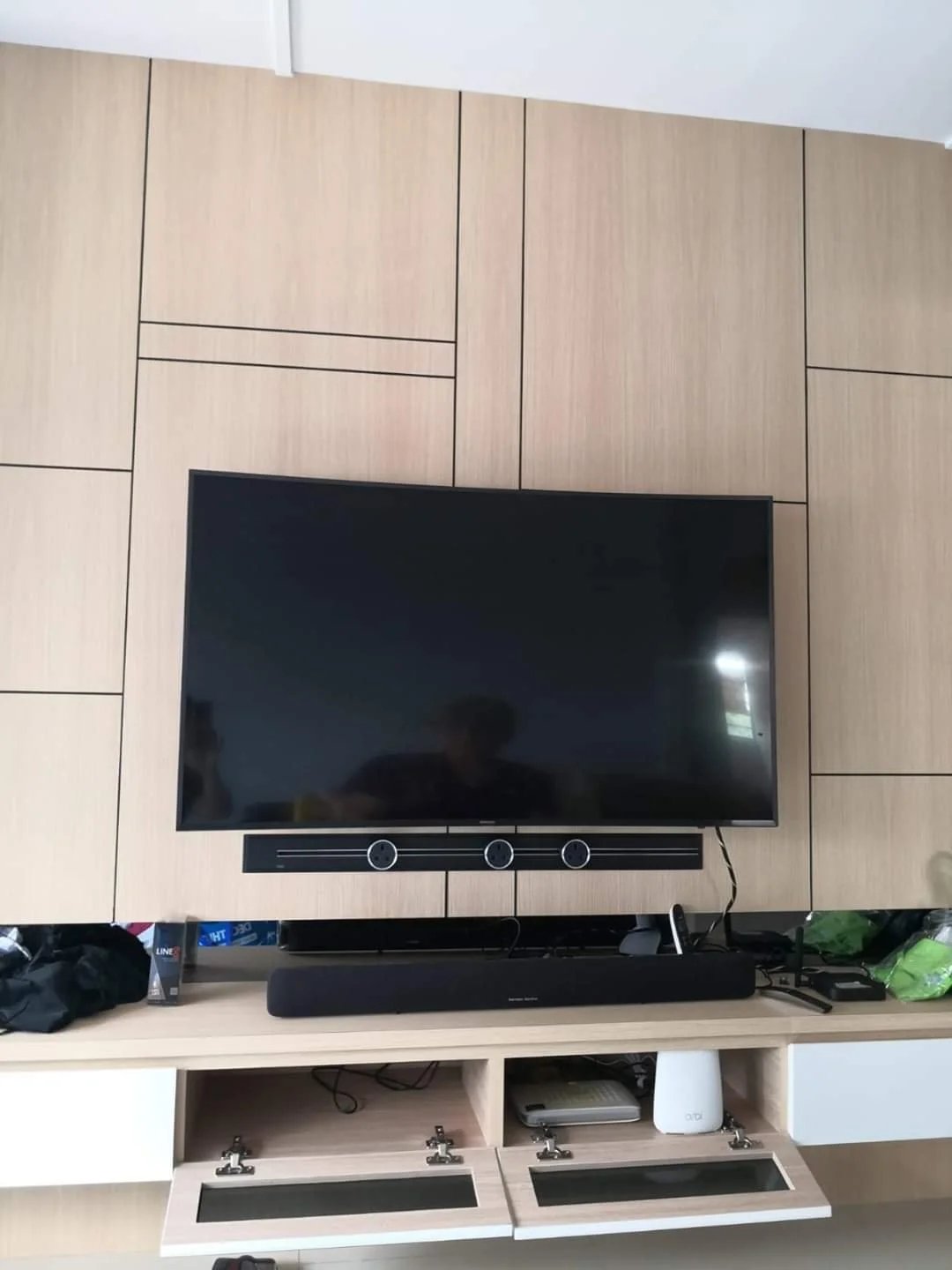 Line8 Model SL track in Black Hairline mounted below a television in a living room