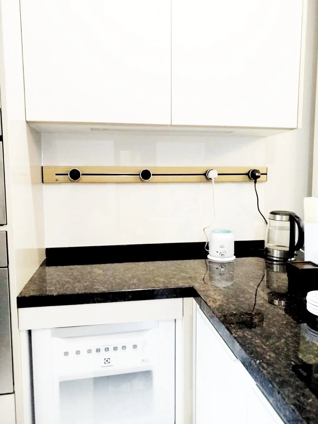Line8 Model SL track in Champagne Gold above a kitchen countertop powering appliances
