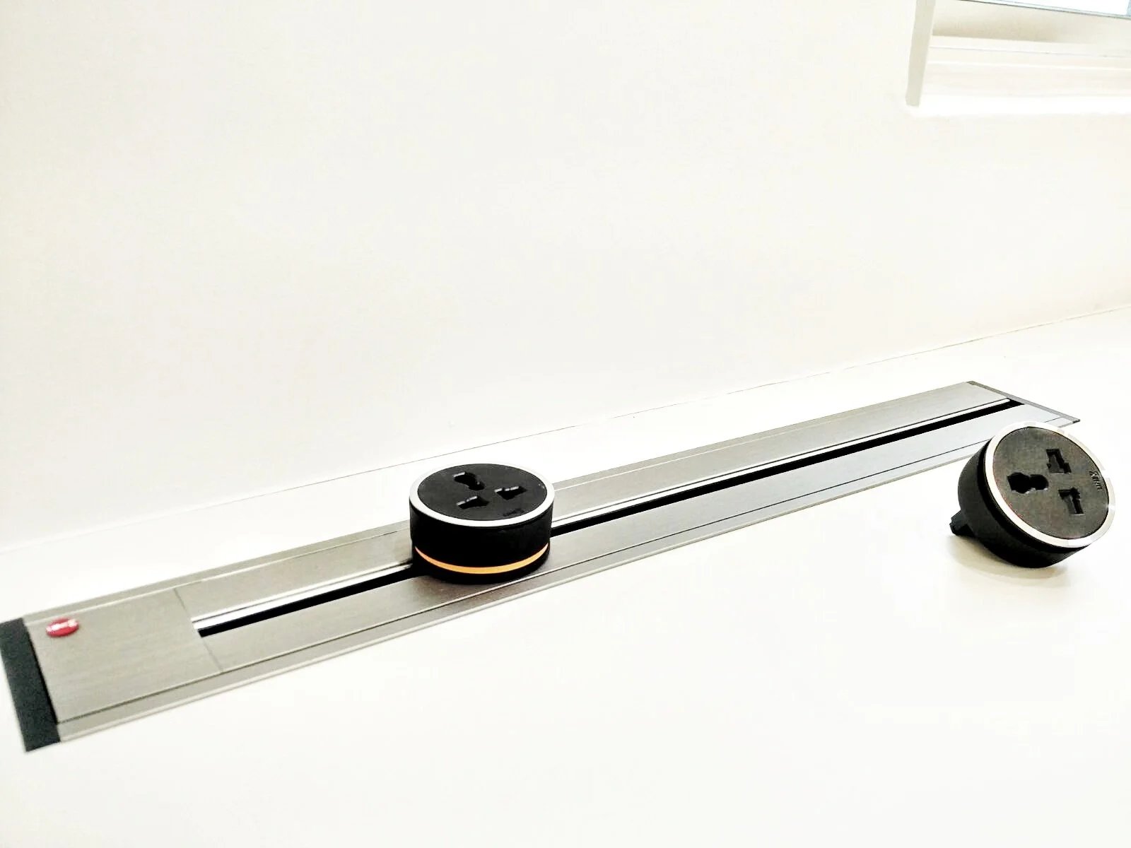 Line8 Model SL track in Silver Hairline on a study desk powering devices
