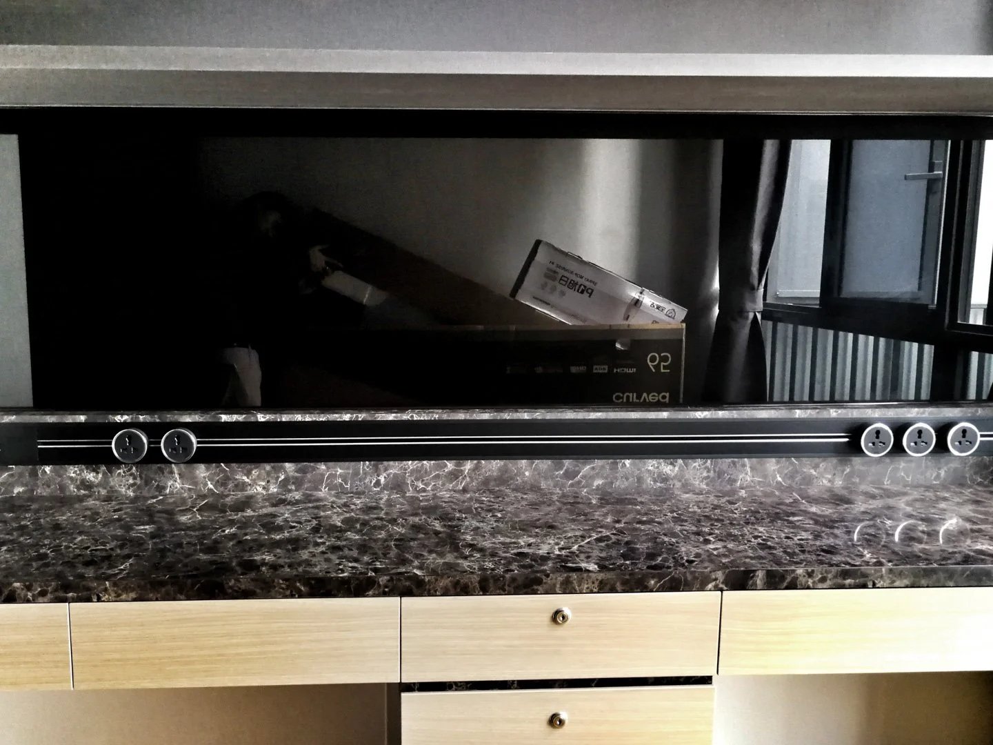 Line8 Model SL track in Black Hairline above a study desk with a marble surface