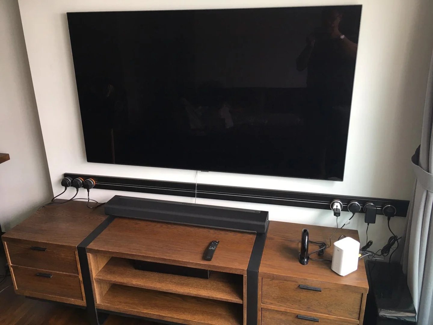 Line8 Model SL track in Black Hairline below a television in a living room