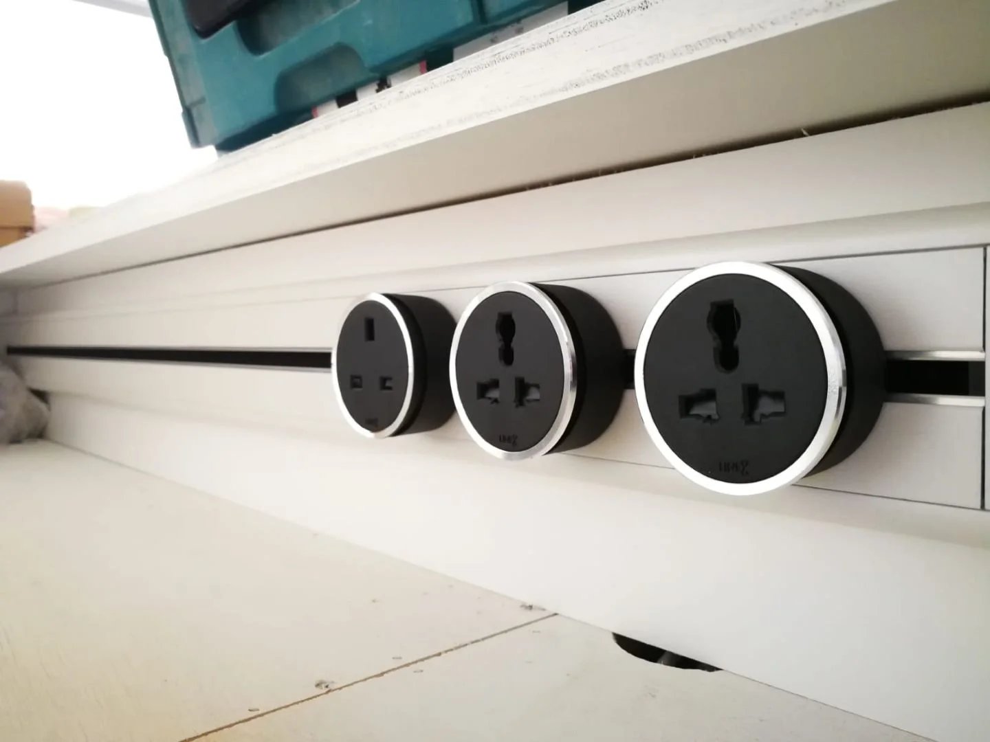 Line8 Model SL track in Black Hairline under a kitchen counter with power outlets