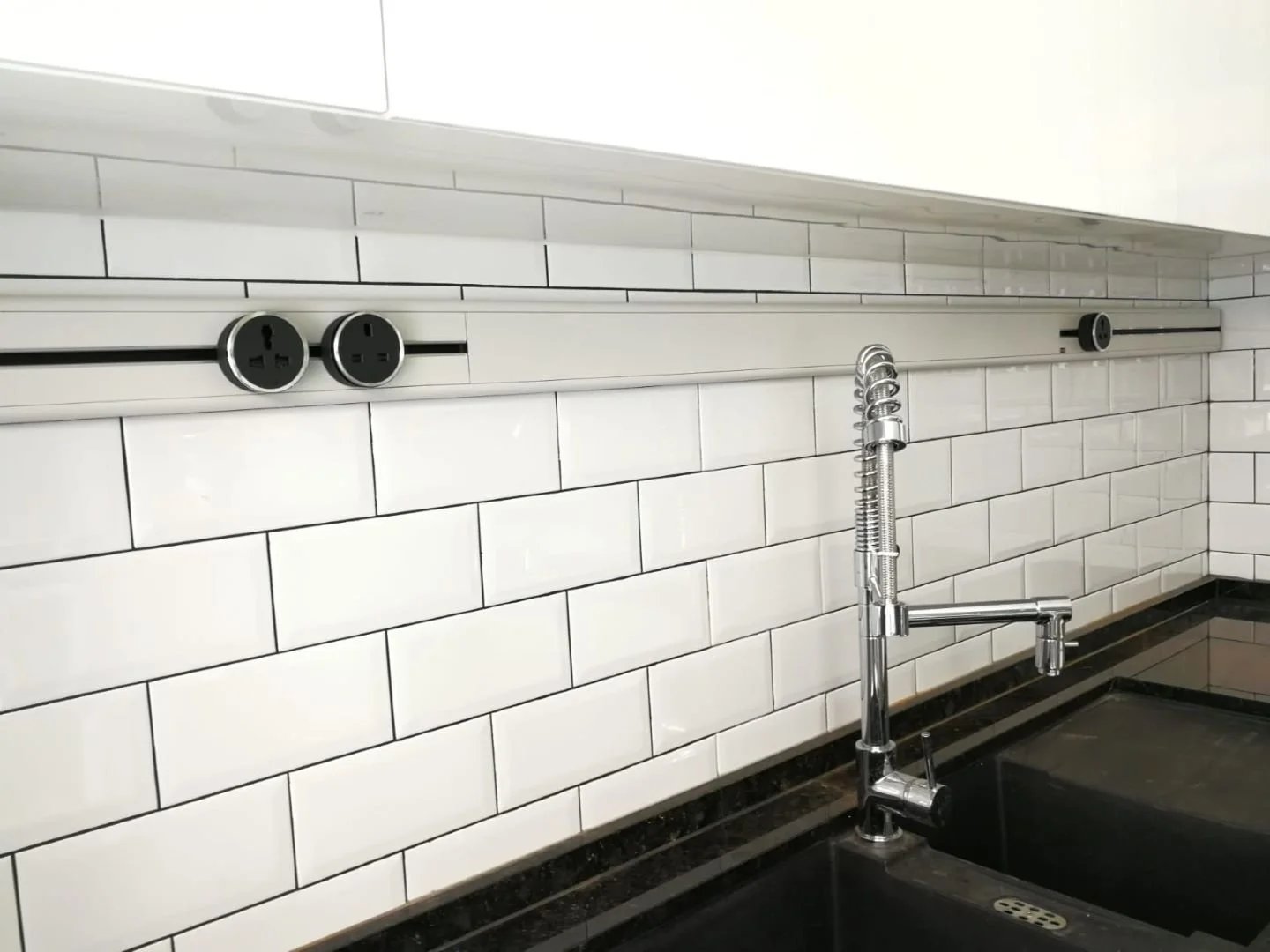 Line8 Model SL track in Silver Hairline above a kitchen sink powering outlets