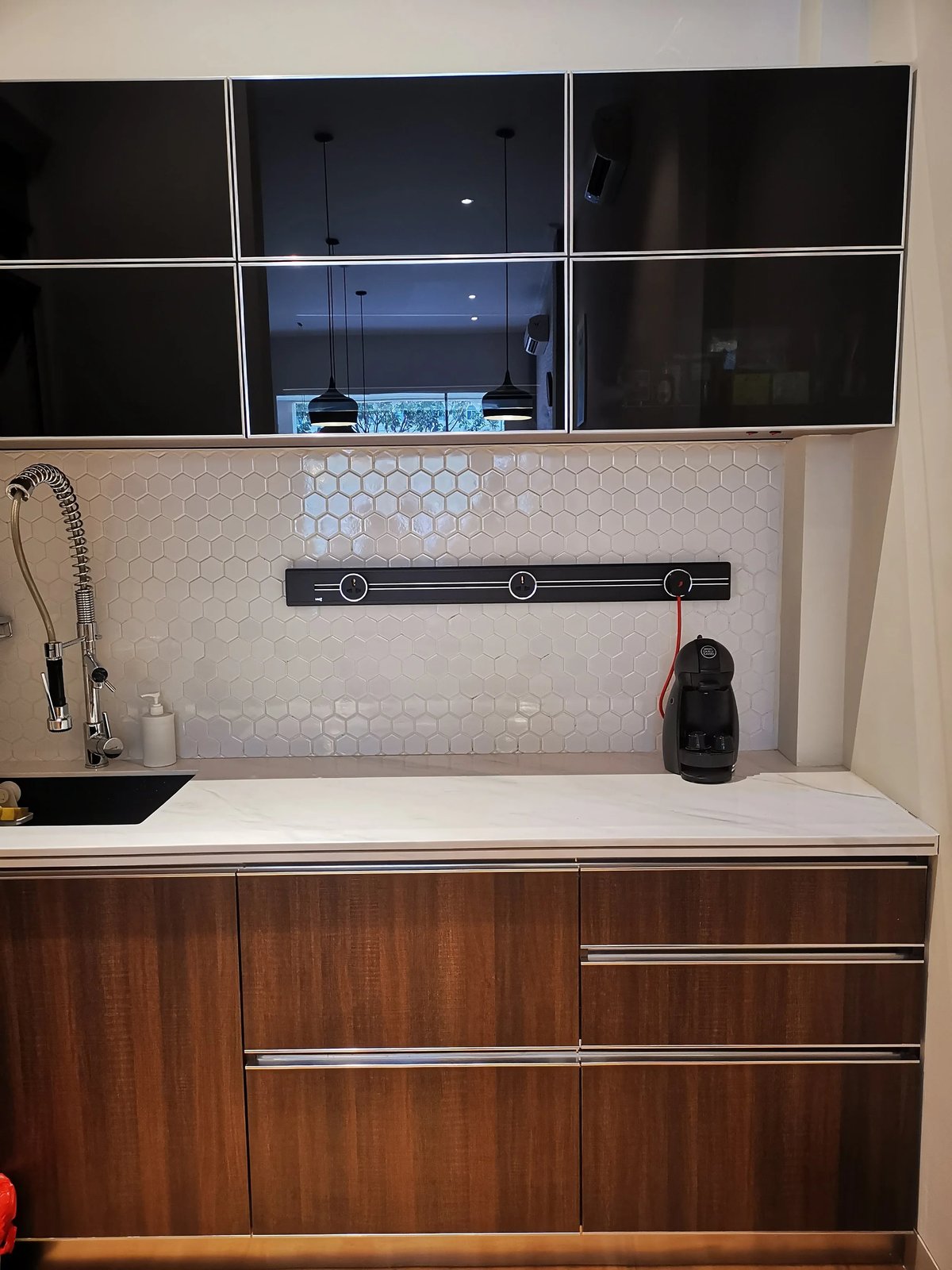 Line8 Model SL track in Black Hairline above the kitchen sink powering a coffee machine