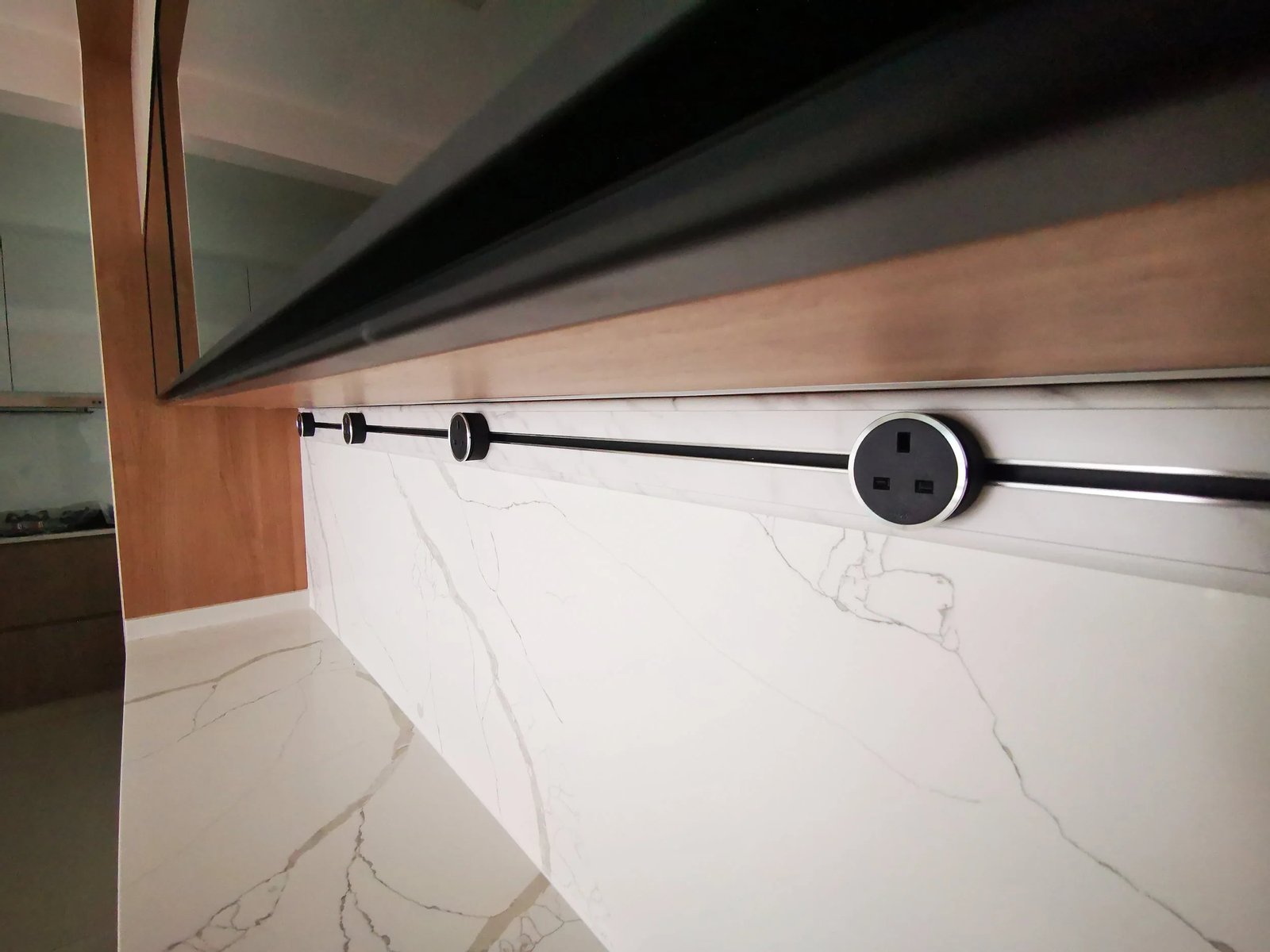 Line8 Model SL track in Black Hairline along the kitchen splashback powering appliances