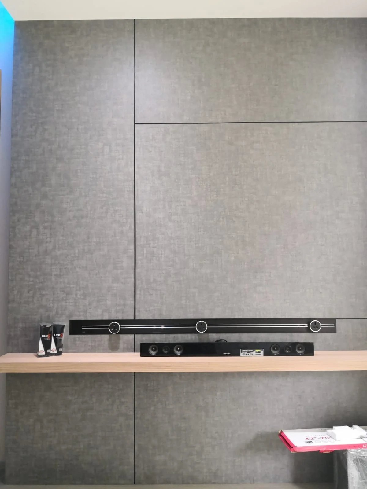 Line8 Model SL track in Black Hairline above a wooden shelf with audio equipment