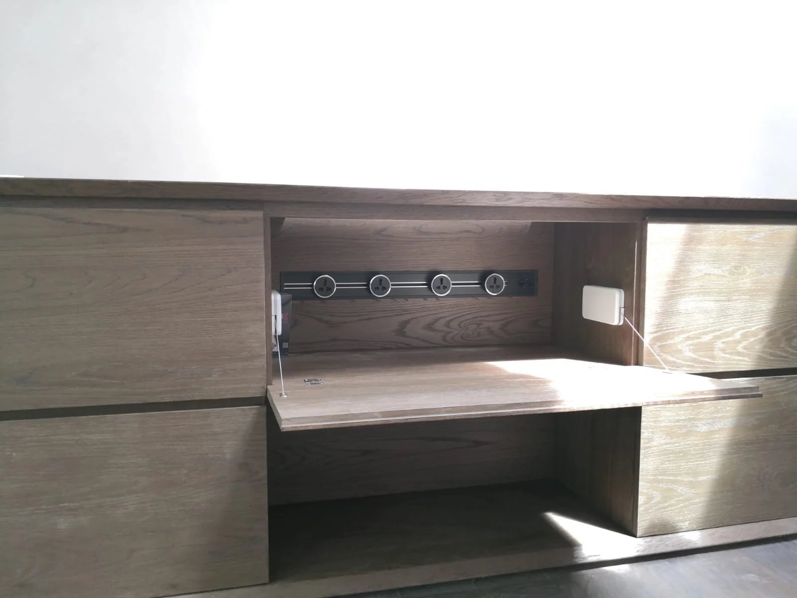 Line8 Model SL track in Black Hairline mounted within a wooden cabinet powering lighting