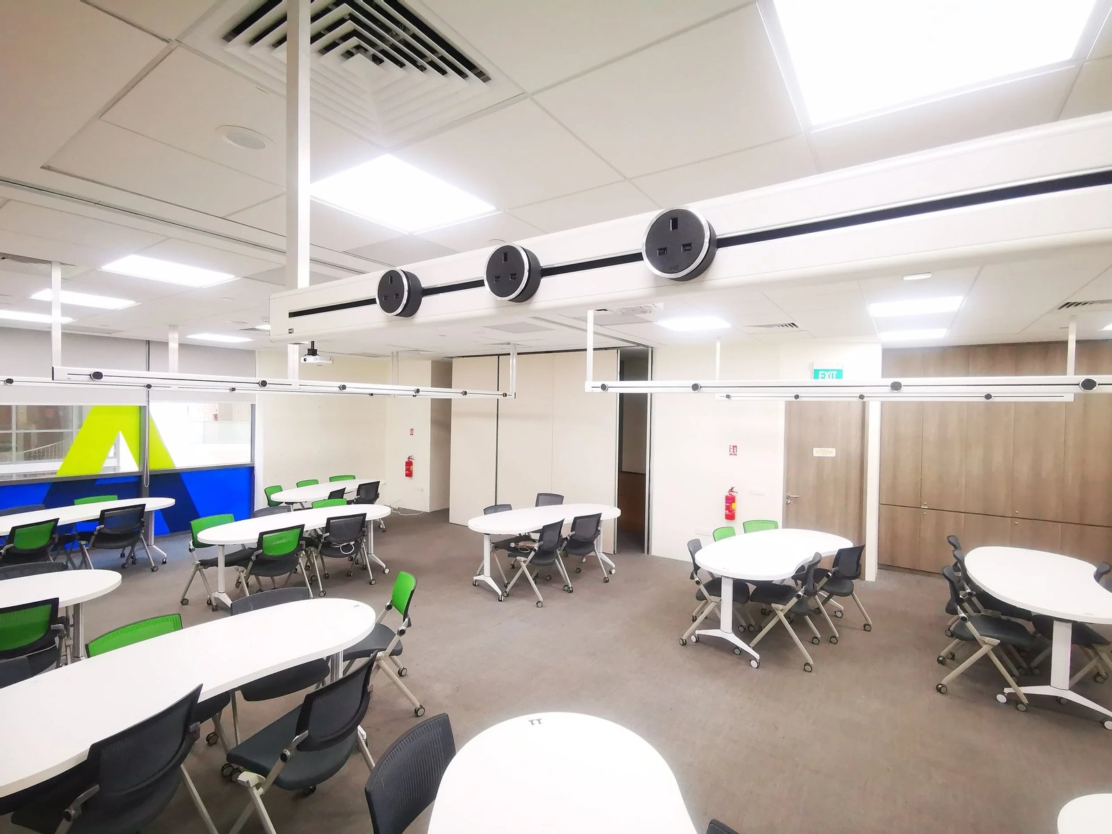 Line8 Model SL track in Black Hairline above a meeting area powering multiple tables