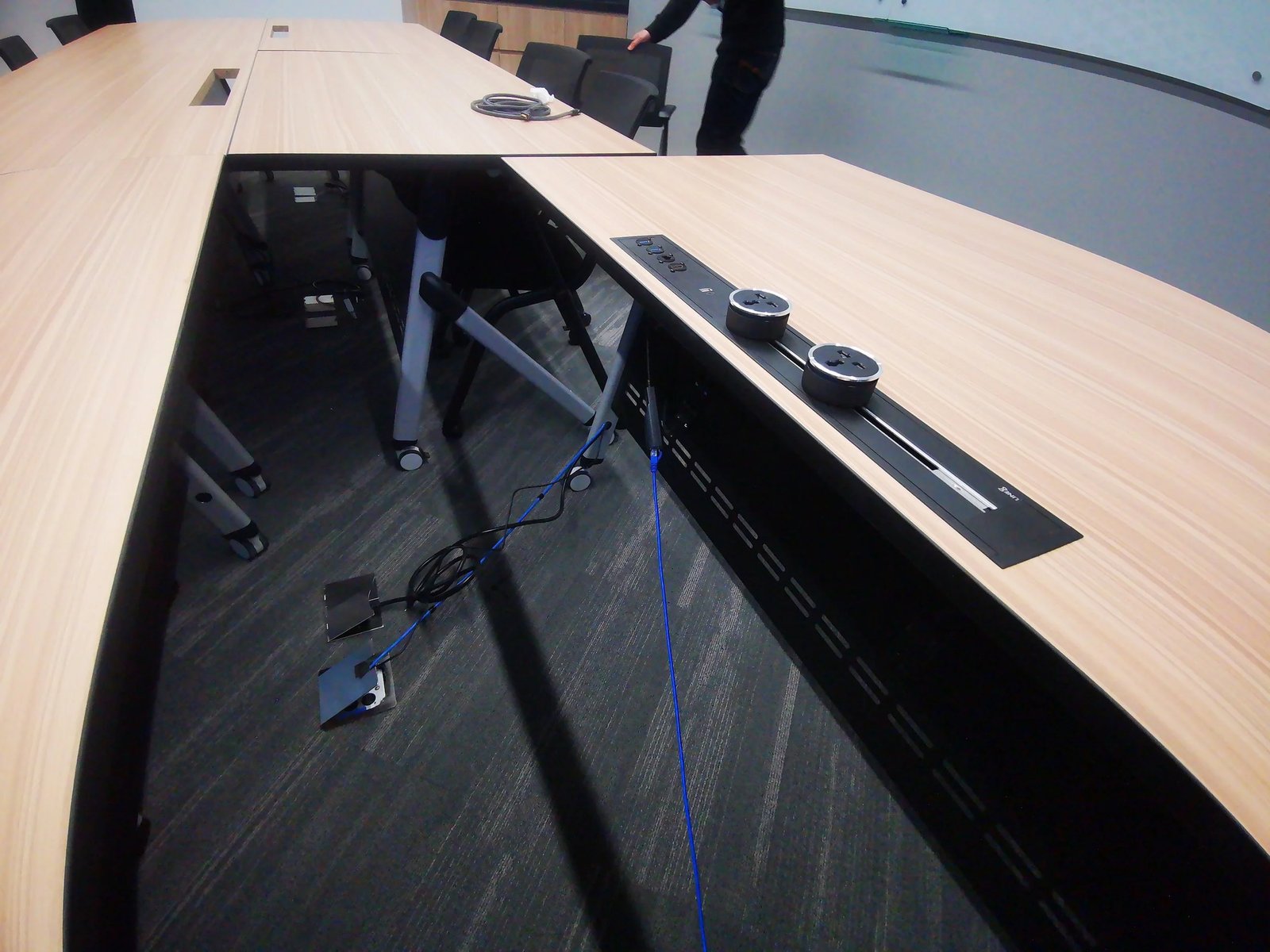 Line8 Model SL track in Black Hairline installed in a conference room powering table connections
