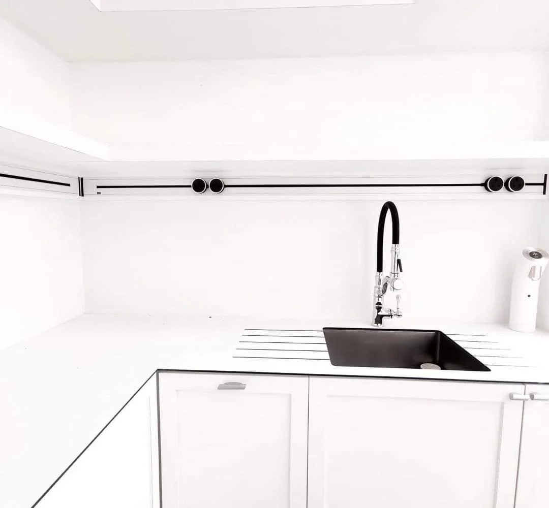 Line8 Model SL track in Black Hairline above a kitchen sink powering lighting fixtures