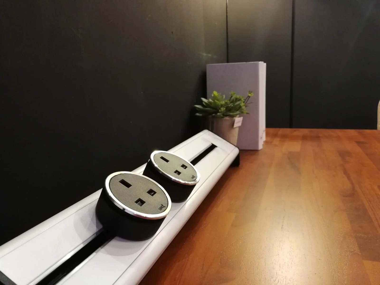 Line8 Model SL track in Silver Hairline on a study desk powering devices