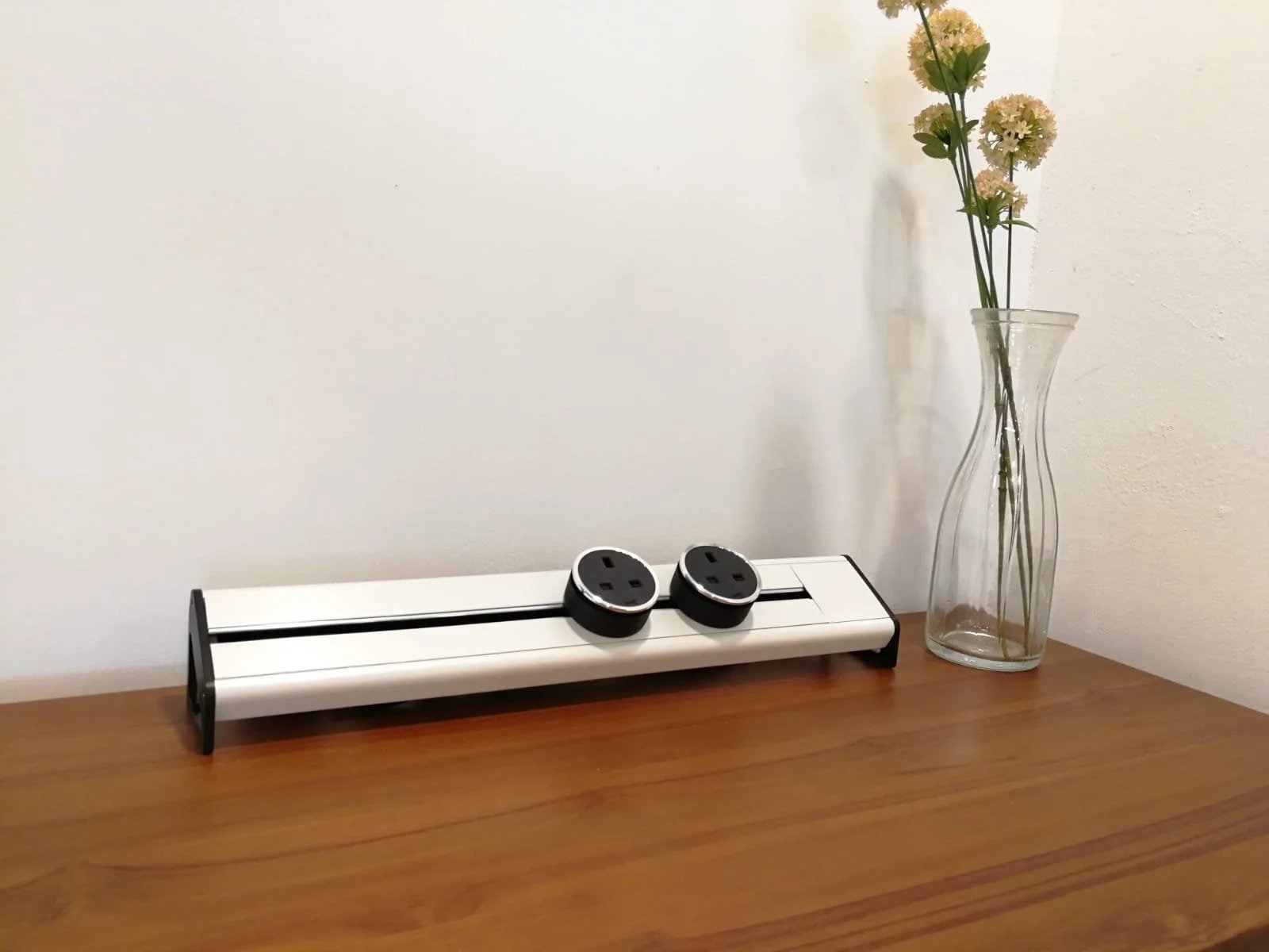 Line8 Model SL track in Pearl White on a wooden desk powering two sockets