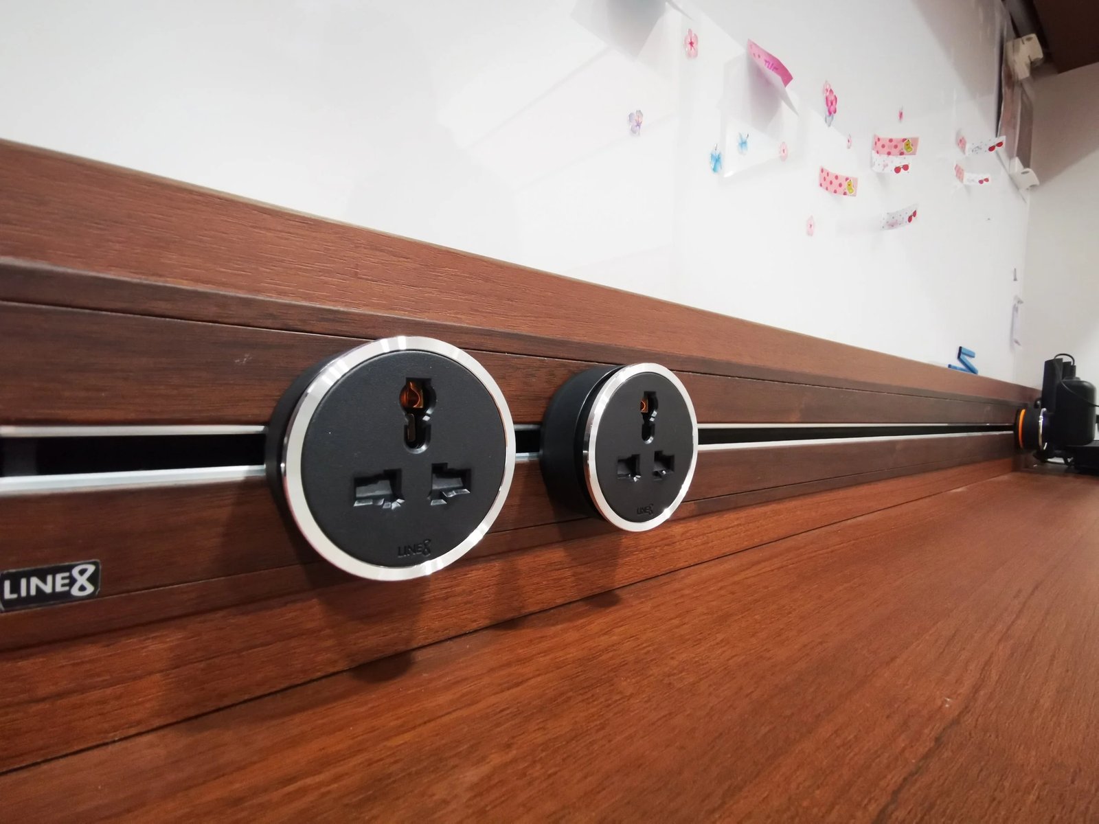 Line8 Model SL track in Burmese Teak above a study desk with power outlets