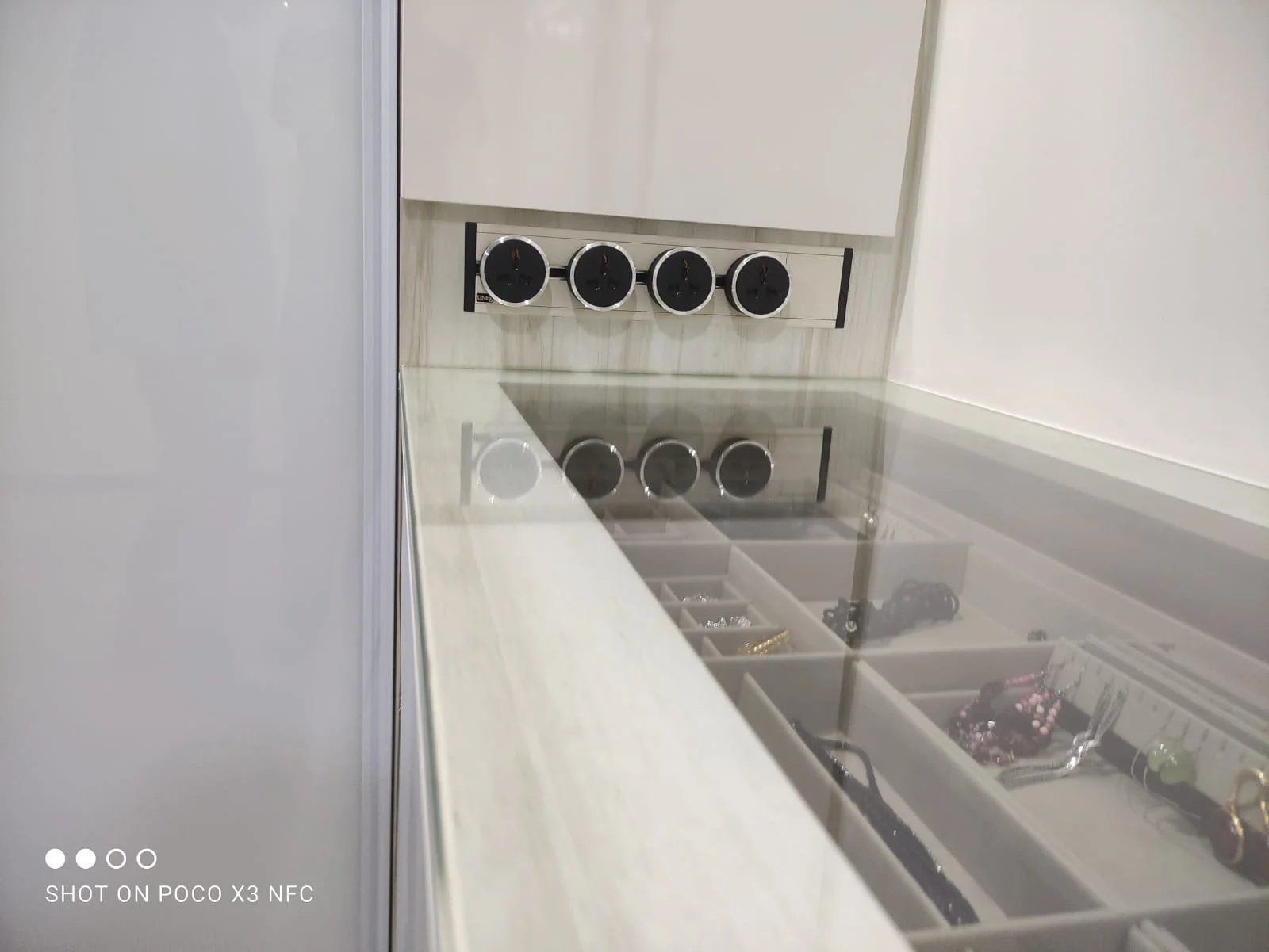Line8 Model SL track in Pearl White above a jewelry organizer in a bedroom