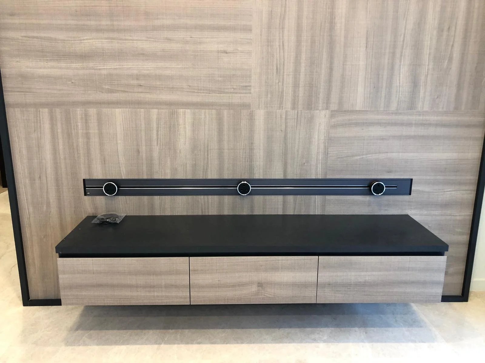 Line8 Model SL track in Black Hairline above a wooden media console