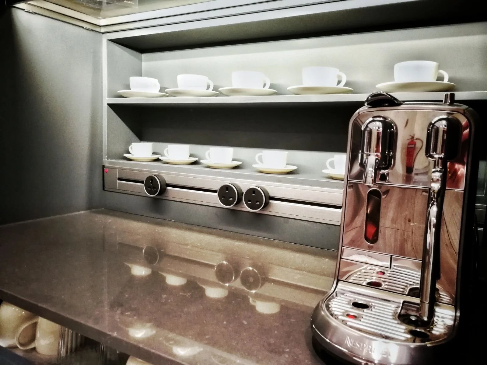 Line8 Model SL track in Silver Hairline above a coffee machine on a countertop