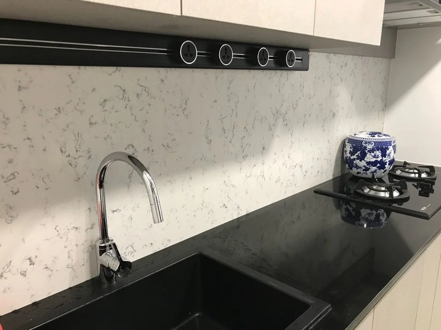 Line8 Model SL track in Black Hairline above a kitchen sink powering lighting