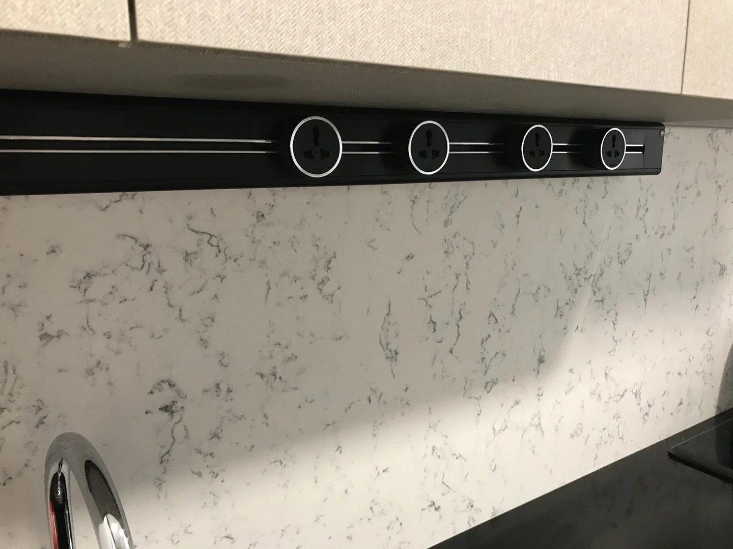 Line8 Model SL track in Black Hairline above a kitchen sink with power outlets