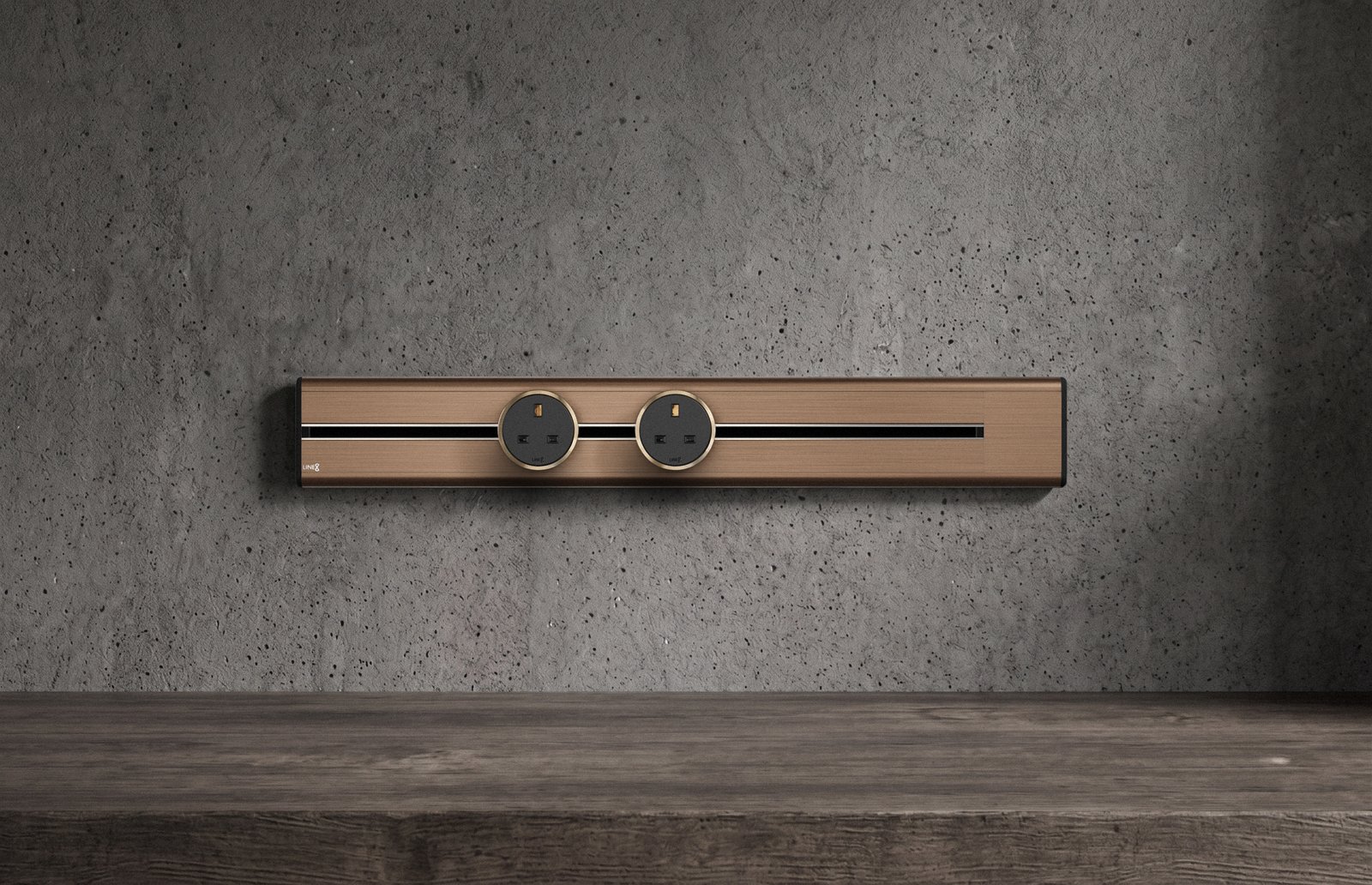 Premium Line8 Model SL electrical power track showcasing an elegant brushed Rosegold finish. Mounted against a textured, industrial-chic concrete wall, the high-end architectural fitting features a contrasting black center channel and includes two circular black power adaptors, positioned perfectly above a rustic, dark wood surface.