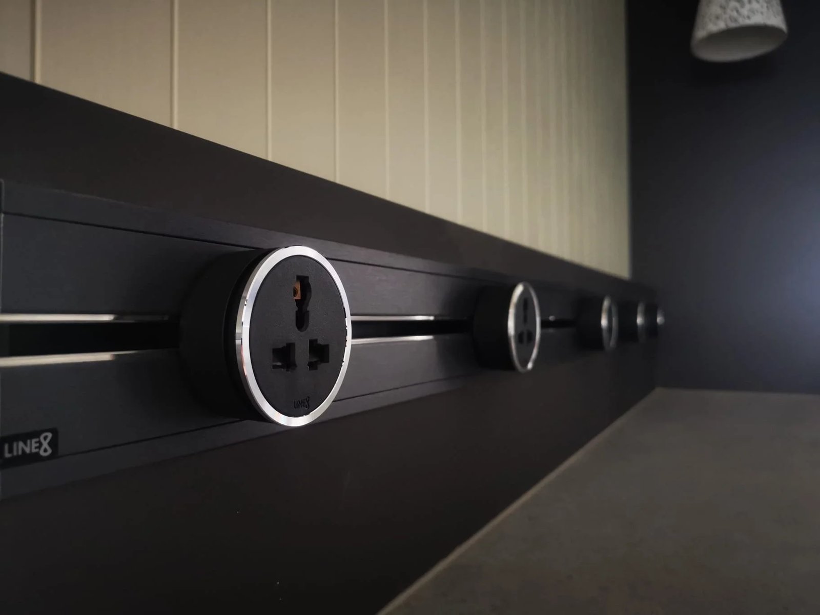Line8 Model SL track in Black Hairline along a kitchen splashback powering outlets