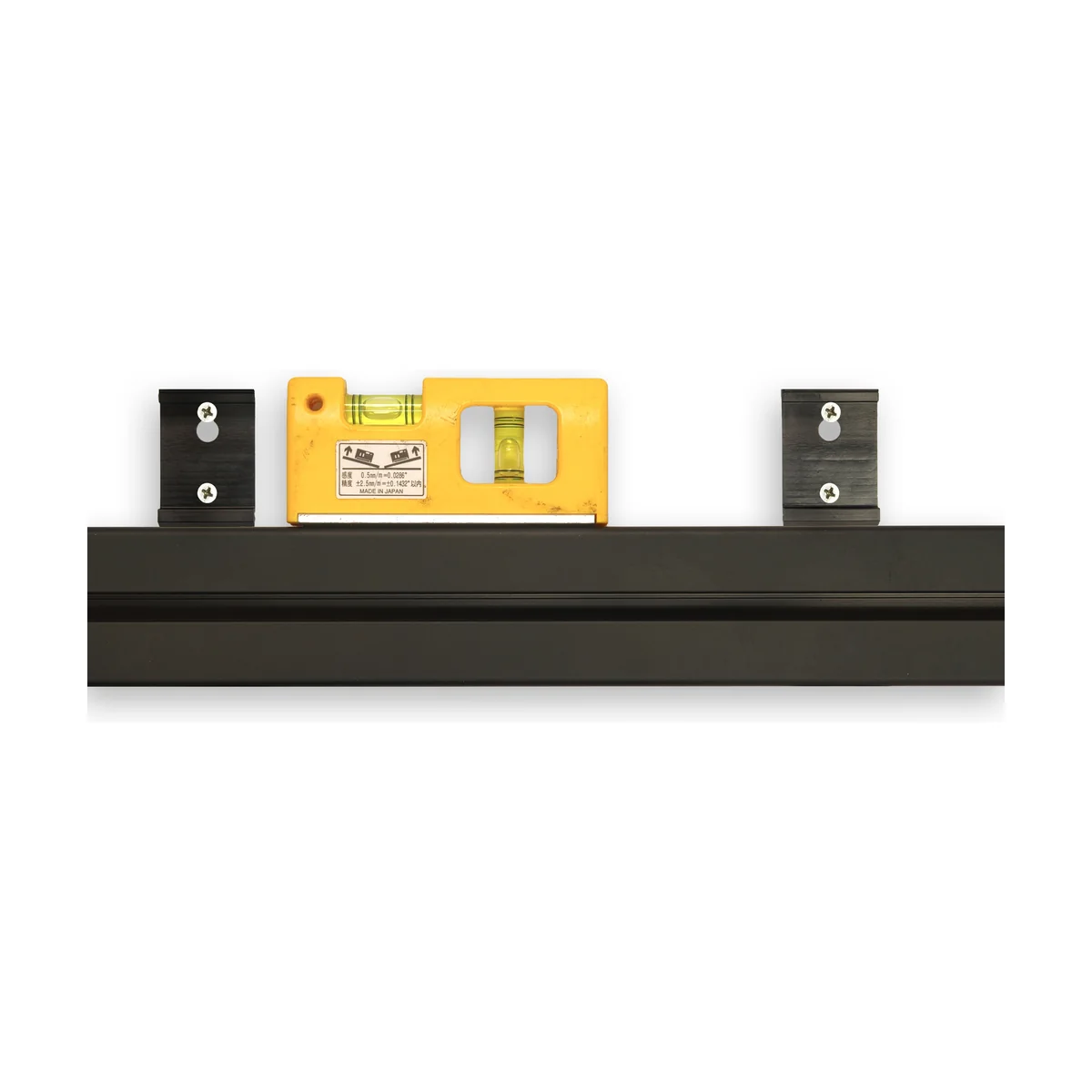 Step 2 — Using the track itself as a straight guide, mark and mount the retaining clips to the wall with a spirit level.
